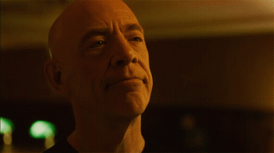 Bald Man With Green Light Behind GIF