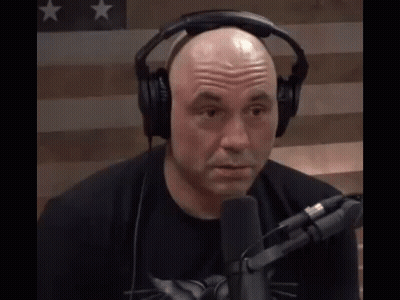 Bald Man With Headphones And Black Shirt At Microphone GIF