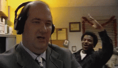 Bald Man With Headphones At Microphone GIF