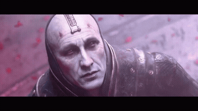 Bald Man With Hood In Front Of Red Wall GIF