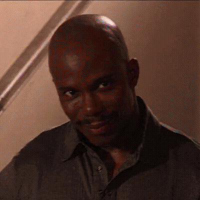 Bald Man With Mustache Looking At Camera GIF