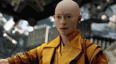 Bald Woman With Cross on Forehead in Yellow Robe