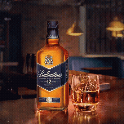 Ballantine's Blended Scotch Whisky Bottle Next To Glass GIF