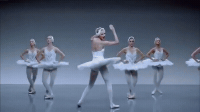 Ballerinas Dancing In A Row On Stage GIF