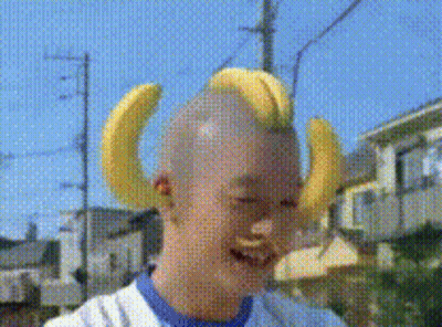 Banana Costume Mascot In Front Of Fruchaland Sign GIF