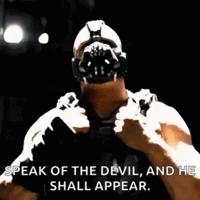 Bane From The Dark Knight Rises Is Wearing A Mask And Saying `` Speak Of The Devil And He Shall Appear . '' GIF