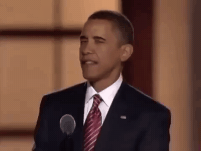 Barack Obama Is Giving A Speech In Front Of A Microphone And Making A Funny Face . GIF