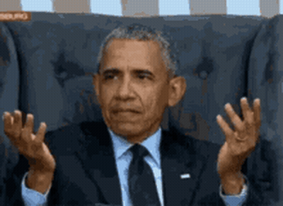 Barack Obama Is Sitting In A Chair With His Hands In The Air GIF