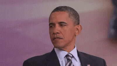 Barack Obama Is Wearing A Suit And Tie And Is Making A Funny Face . GIF