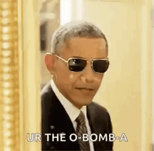 Barack Obama Is Wearing Sunglasses And A Suit And Tie And Is Standing In Front Of A Mirror . GIF