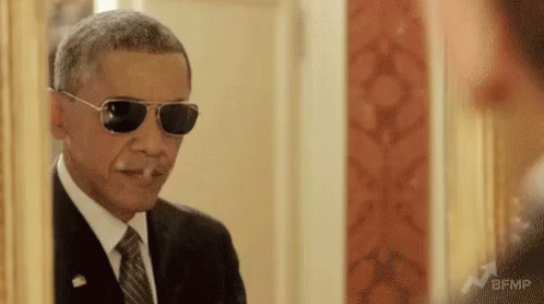 Barack Obama Is Wearing Sunglasses And Smoking A Cigarette . GIF