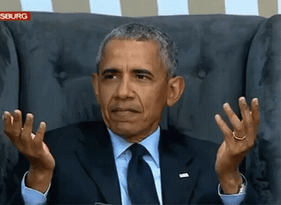 Barack Obama Sitting In A Chair With His Hands Up GIF