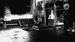 Barbell Row In Dark Themed Gym GIF
