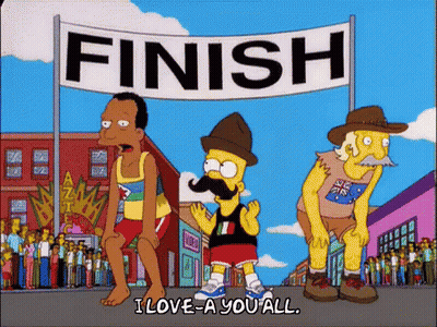 Bart Simpson Is Standing In Front Of A Finish Line Banner GIF