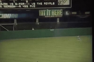 Baseball Game In Front Of Hit It Here Sign GIF