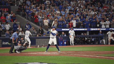 Baseball Game in Front of Loan Banner