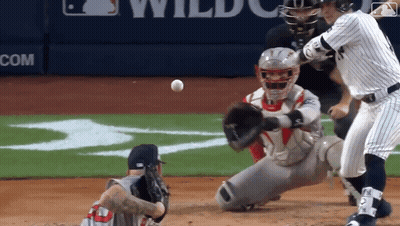Baseball Game In Front Of Wildcats Banner GIF