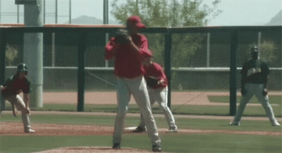 Baseball Pitcher In Red Uniform About To Throw GIF