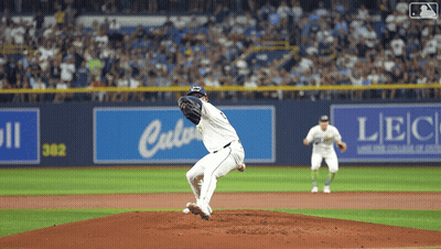 Baseball Pitcher Winding Up In Front Of LBC Sign GIF