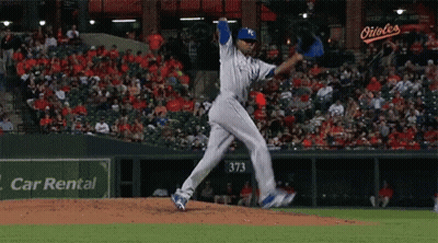 Baseball Pitcher Winding Up To Throw In Front Of Car Rental Sign GIF