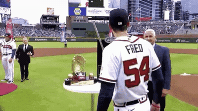 Baseball Player 54 With Trophy On Table GIF