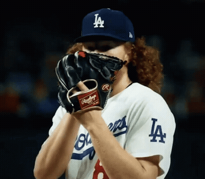 Baseball Player Covering Face With LA Hat And Glove GIF