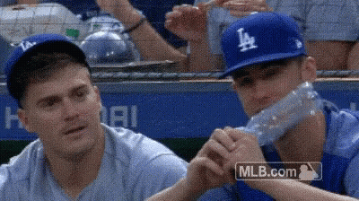 Baseball Player Drinking Water While Another Watches GIF
