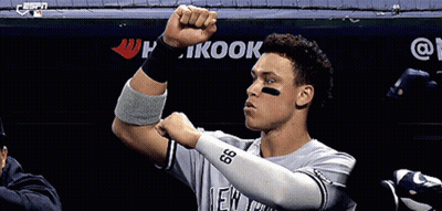 Baseball Player Flexing In Front Of Kook Banner GIF