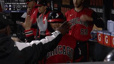 Baseball Player High Fives Teammate