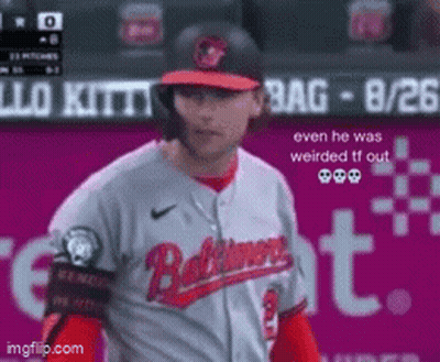Baseball Player In Baltimore Jersey In Front Of Pink Sign GIF
