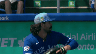 Baseball Player In Blue Jays Jersey Holding Glove GIF