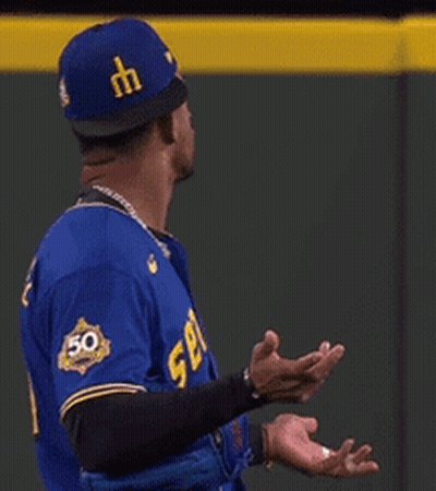 Baseball Player In Blue Jersey Number 50 GIF