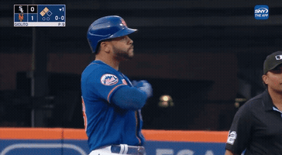 Baseball Player In Blue Mets Jersey Standing In Front Of Scoreboard GIF