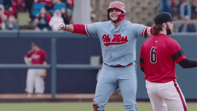 Baseball Player In Blue Ole Miss Jersey Next To Player In Red Jersey Number 6 GIF