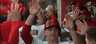 Baseball Player In Helmet With A High Five GIF
