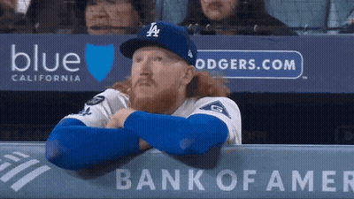 Baseball Player in LA Hat and Glove Covering Face