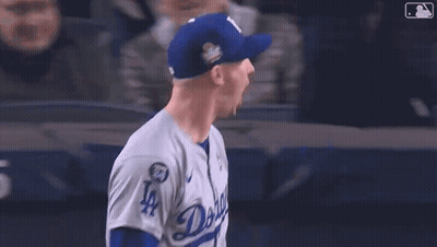 Baseball Player In LA Hat In Front Of Yankees.com Sign GIF