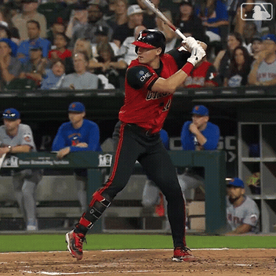 Baseball Player In Red And Black Bulls Uniform Swinging At Pitch GIF