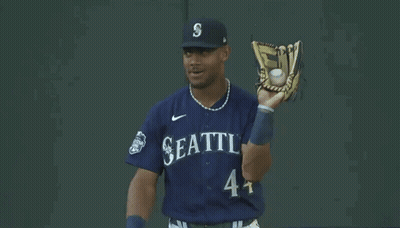 Baseball Player in Seattle Uniform Holding Glove