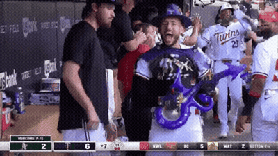 Baseball Player In Twins Jersey Holding Blue Balloon GIF