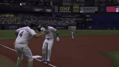 Baseball Player In White And Purple Uniform GIF
