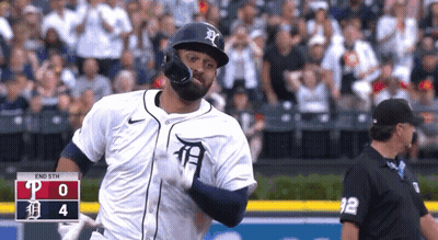 Baseball Player in White Tiger Jersey Running to Home Plate