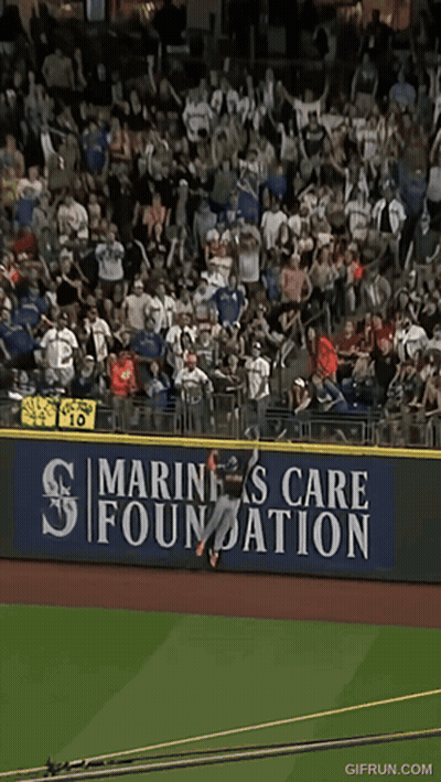 Baseball Player Jumping Over Fence GIF