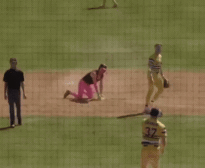 Baseball Player Kneeling In Pink Pants And Helmet GIF