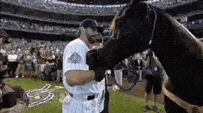 Baseball Player Petting Horse On Field GIF