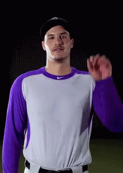 Baseball Player Purple and White Jersey Black Hat