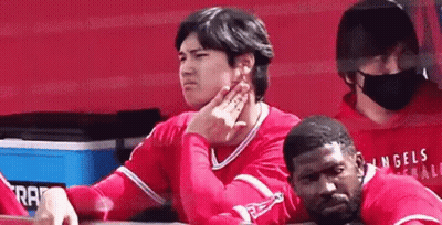 Baseball Player Sitting In Dugout With Hand On Chin GIF