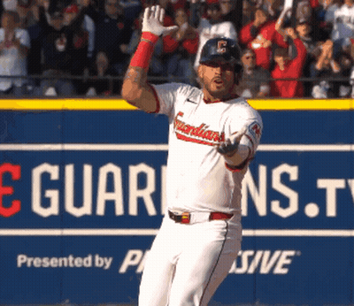 Baseball Player Standing In Front Of Guardians.tv Sign GIF