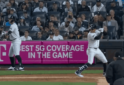 Baseball Player Swinging At Ball In Front Of 5G Ad GIF