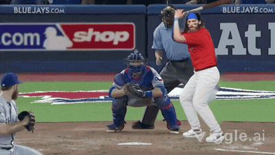 Baseball Player Swinging At Ball In Front Of Blue Jays Sign GIF